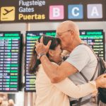 Couple of senior people hugging and goodbye in airport area for arriving or departing trip